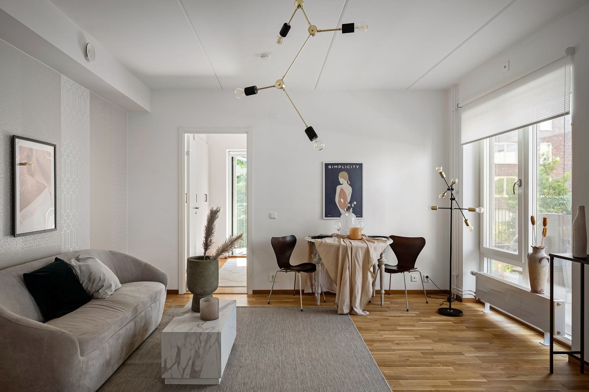 Jasny nowoczesny salon z minimalistycznymi meblami i dużą ilością światła
